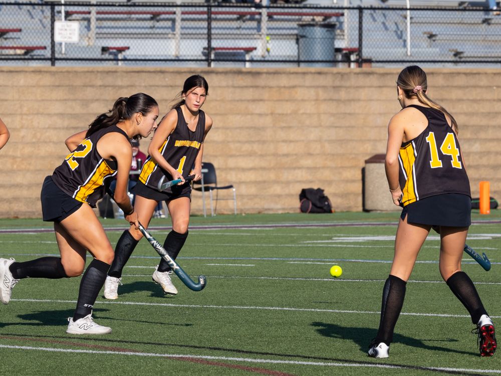 Field hockey players moving together